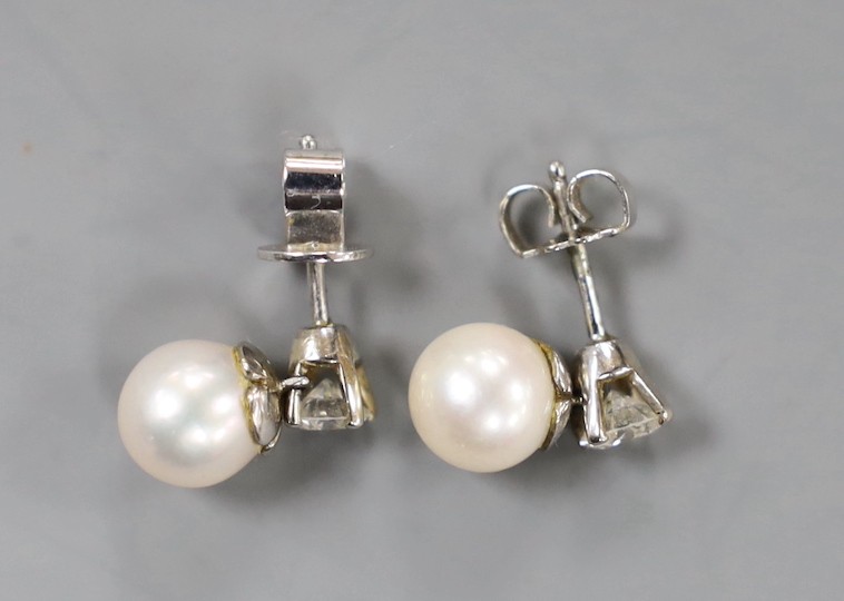 A pair of white metal cultured pearl and single stone diamond set ear studs (butterflies differ) pearl diameter 6.8mm, gross weight 2.7 grams.